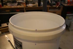 Evenly spaced marks around the top of the bucket